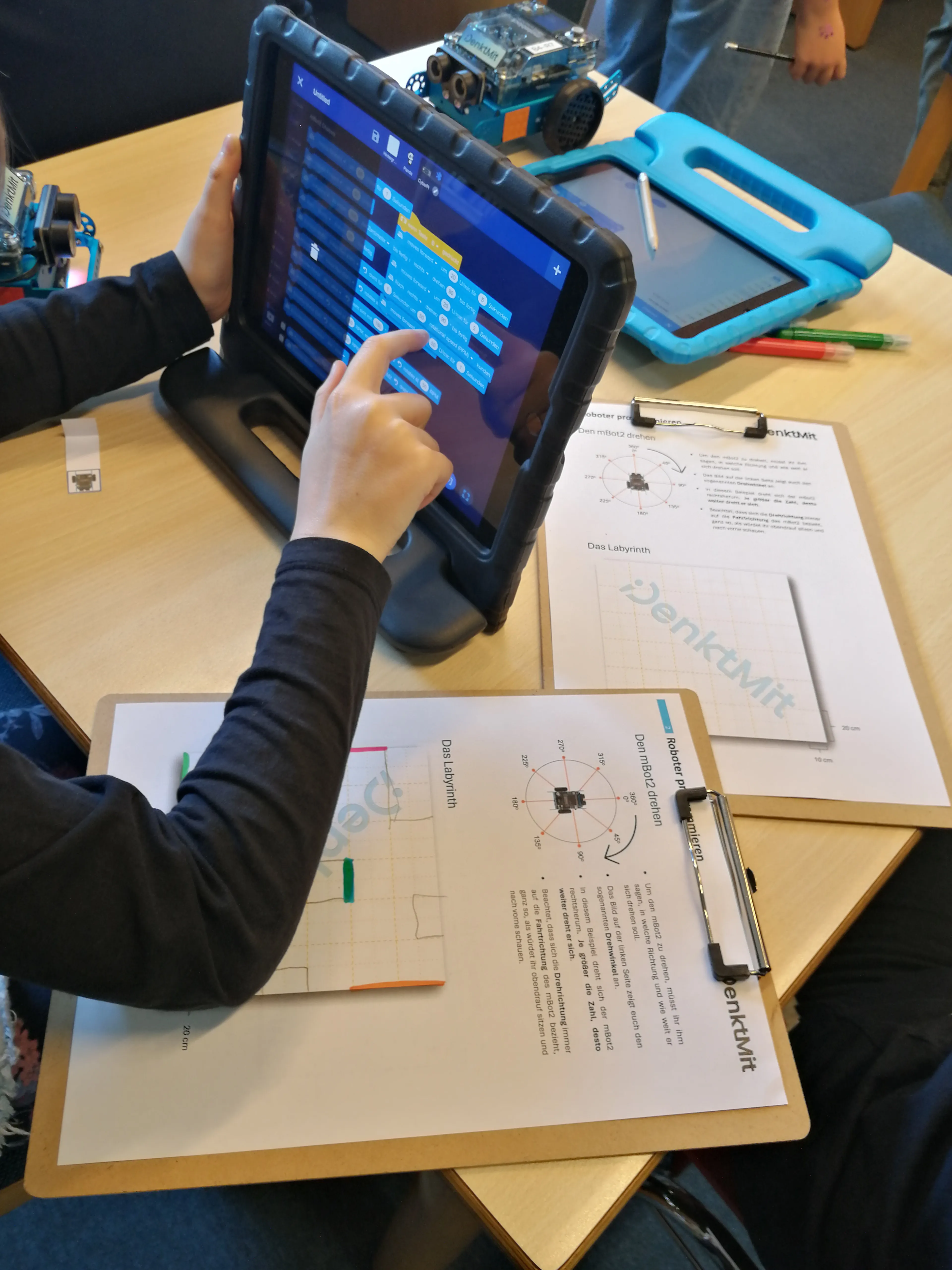 iPad auf dem gerade ein mBot2 mittels Blockly programmiert wird